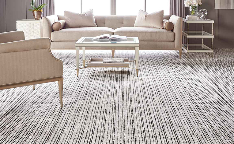 Formal living room with a neutral design scheme and patterned carpets